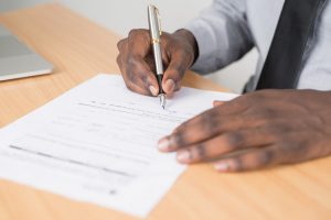Person filling out insurance form